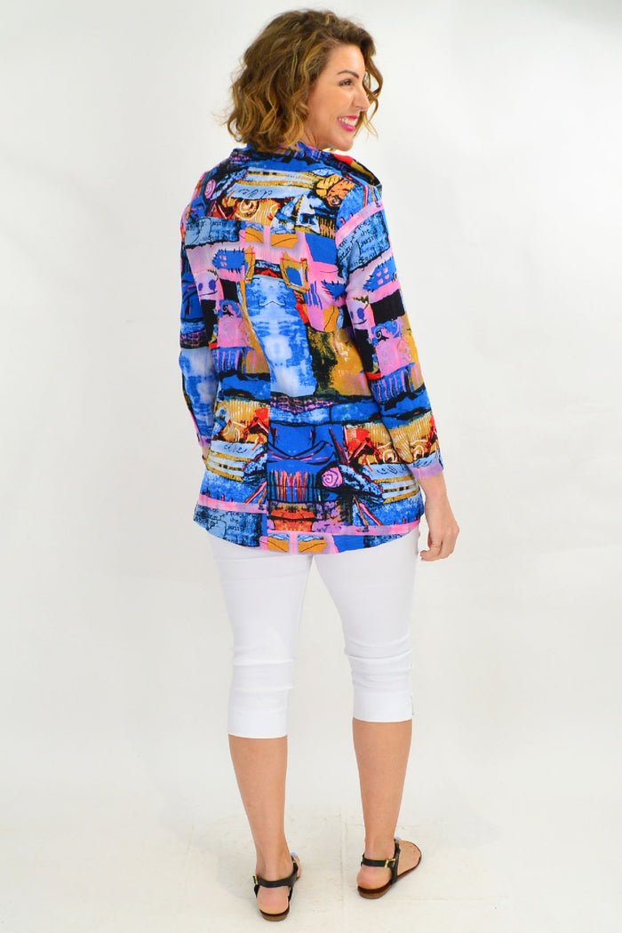 Blue swirl print Ruby Rain train high collar tunic shirt displayed on a hanger, showcasing its stylish design and vibrant pattern.