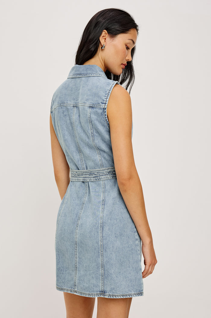 Aurora Sleeveless Mini Dress in TENCEL™Denim With Collar Front Exposed Zipper Adjustable Belted Ties Side Flap Pockets in Faded Indigo Colorway - Upper Body Back View Featured on Model