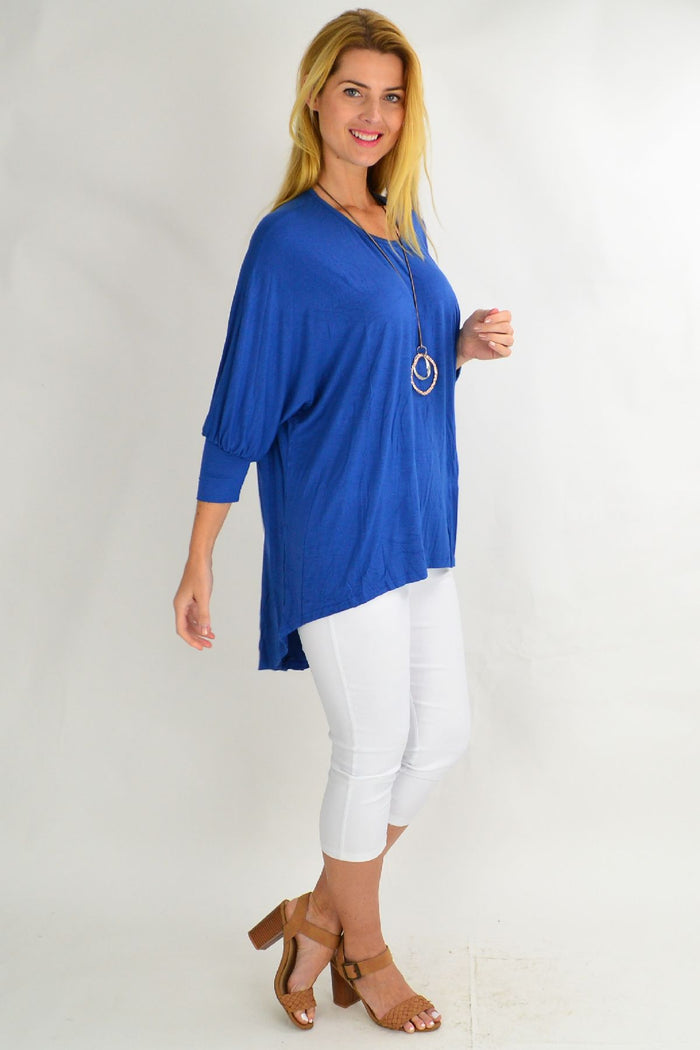 Blue bamboo tunic top by Hourglass, flowing fabric with long sleeves and a relaxed fit, displayed on a hanger.
