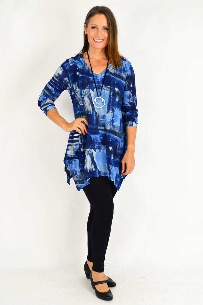 Blue Nova Stylius tunic top with long sleeves and relaxed fit, displayed on a hanger with a soft, flowing fabric.