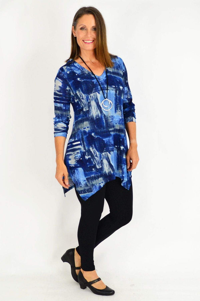 Blue Stylius Nova tunic top with long sleeves and relaxed fit, displayed on a hanger.