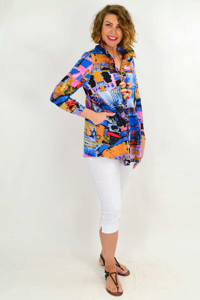Blue train-themed high collar tunic shirt by Ruby Rain with long sleeves and button details, displayed on a white background.