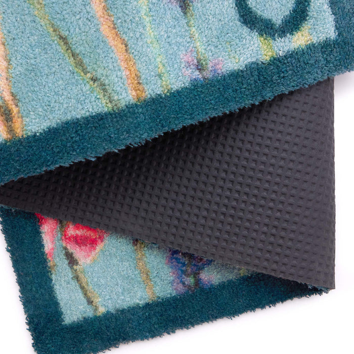 Butterfly Garden Blue Washable Doormat showing black backing and a blue border.