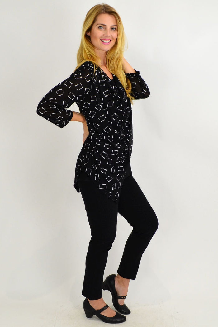 Stylius Carols black and white cowl neck tunic top with long sleeves and relaxed fit, displayed on a hanger.