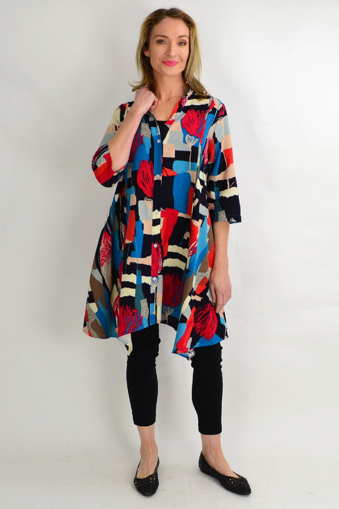 Colorful tulip stand collar long tunic shirt by Hourglass with vibrant line pattern and relaxed fit.