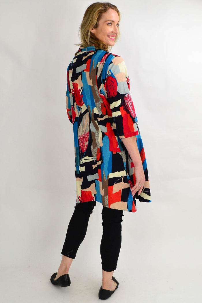 Colorful tulip stand collar long tunic shirt by Hourglass featuring a vibrant lines pattern and relaxed fit.