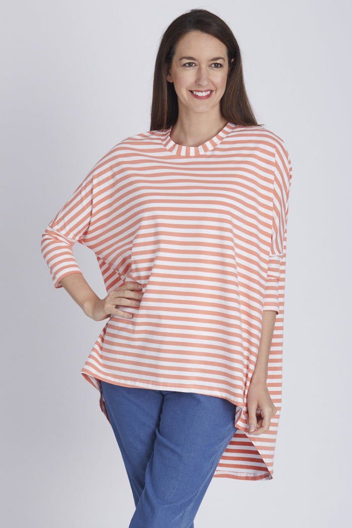 Coral Swing Stripe Tunic Top by Cordelia St featuring a relaxed fit, vertical stripes, and a flowy silhouette.