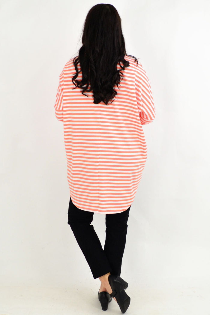 Pink and white long-sleeve Coral Swing Stripe Tunic Top by Cordelia St, featuring a relaxed fit and stylish pattern.