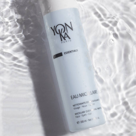Eau Micellaire Cleanser Makeup remover | Yon-Ka Paris bottle partially submerged in clear water with gentle ripples, highlighting skincare and cleansing benefits.