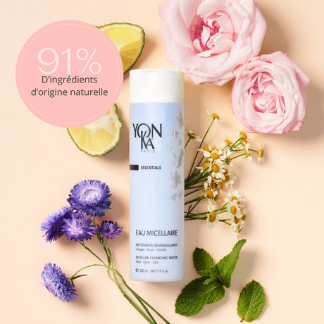 Eau Micellaire Cleanser Makeup remover | Yon-Ka Paris bottle surrounded by natural ingredients including flowers, lime, and mint leaves, highlighting 91 percent natural origin ingredients.