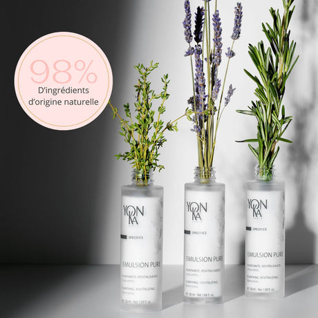 Three bottles of Emulsion Pure Purifying Tonic | Yon-Ka Paris displayed with sprigs of natural herbs, highlighting 98 percent natural origin ingredients for gentle skincare.