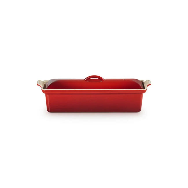 A red rectangular casserole dish with a matching lid, featuring beige-tone metal handles on the sides, shown against a plain white background.