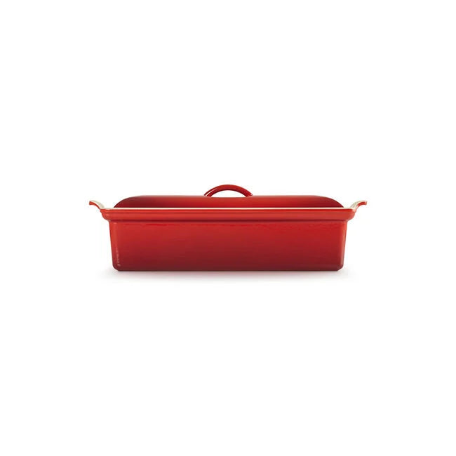 A red rectangular casserole dish with a matching lid, featuring side handles and a top handle, shown on a plain white background.