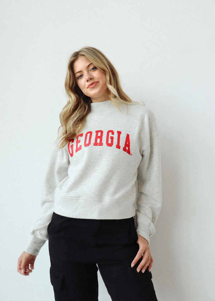 Georgia Bulldogs Women's Ash-Grey Relaxed, waist-length Heavyweight Fleece Sweatshirt with mock neck, drop shoulders and balloon sleeves