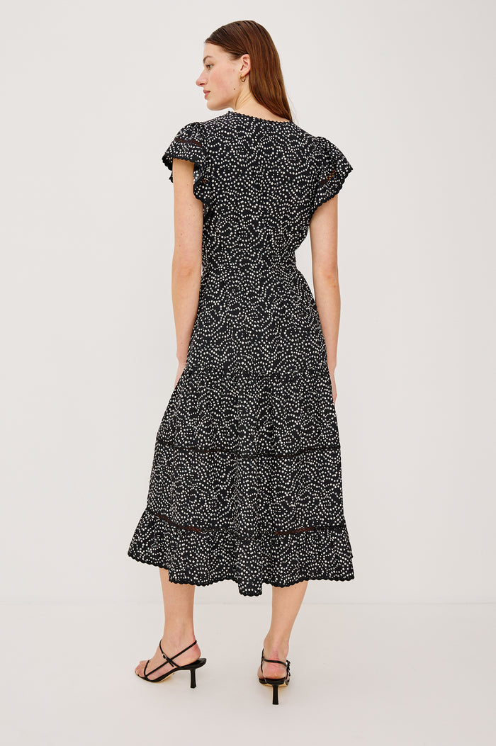 Gia Mini Dress in Crinkle Poplin With Adjustable Waist Ties Split V-Neck Collar Wide Short Sleeves Ladder and Crochet Trim Detailing and Relaxed FIt in Mini Chain Daisies Colorway - Full Body View Featured on Model