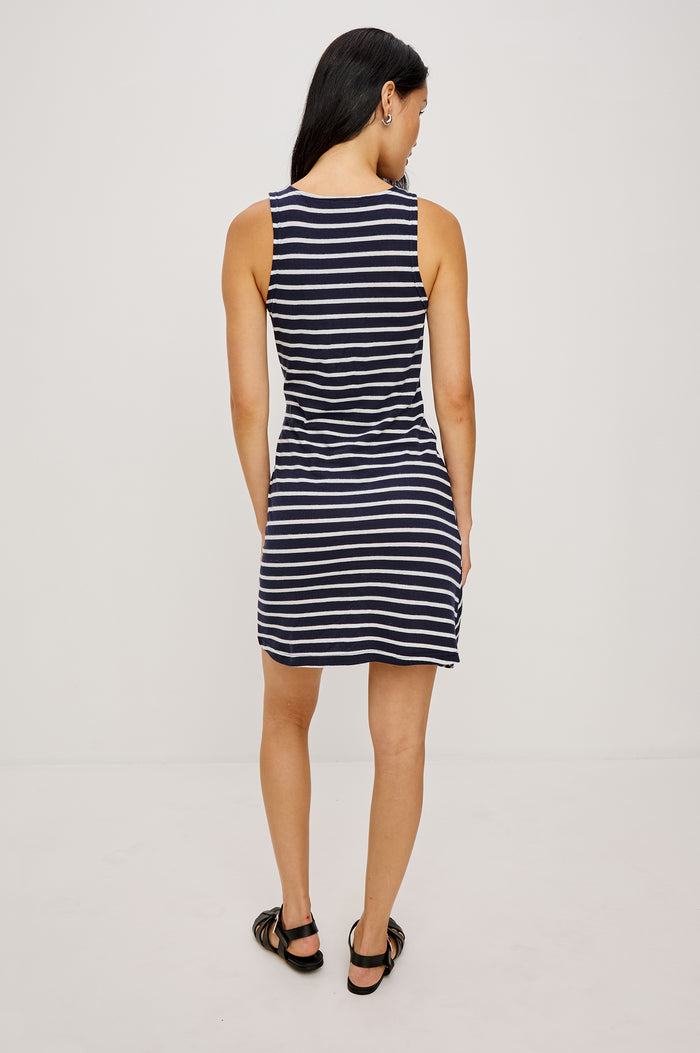 Harriet Mini Dress in Cotton With HIgh Neckline Waist Wrap Ties and A-Line SKirt in Navy Ivory Stripe Colorway - Full Body Back View Featured on Model