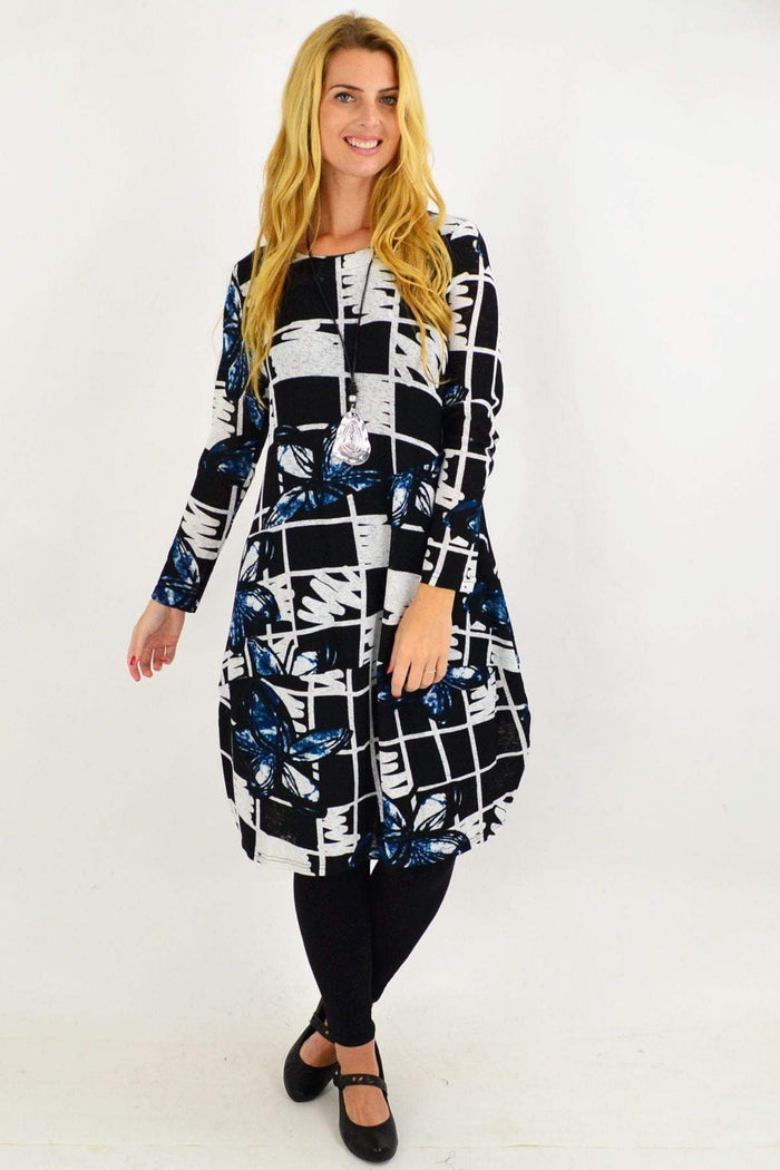 Vuios Heidi floral cocoon tunic dress with vibrant flower pattern, flowing silhouette, and comfortable fabric on a model.