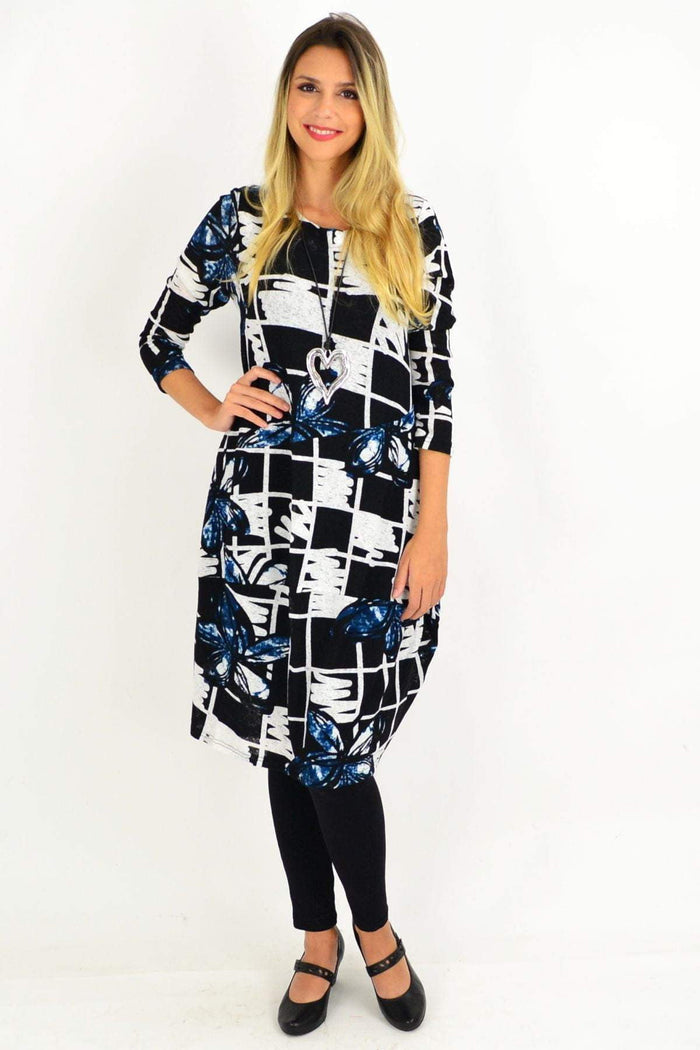 Vuios Heidi floral cocoon tunic dress with vibrant floral pattern, relaxed fit, and soft fabric, displayed on a hanger.