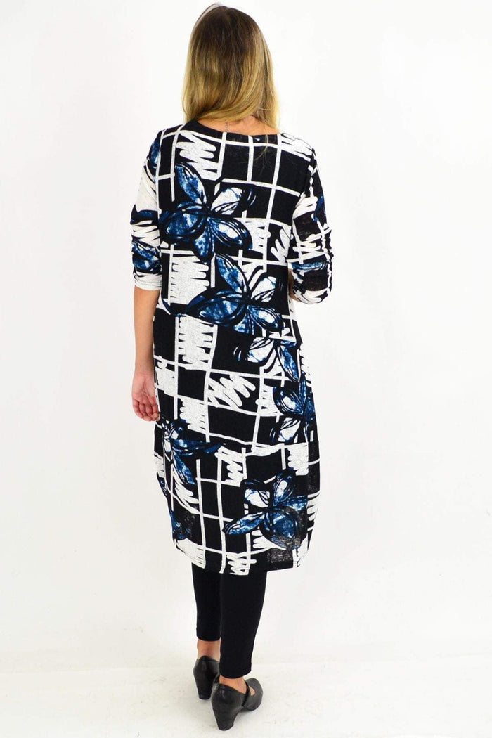 Vuios Heidi Floral Cocoon Tunic Dress displayed on a hanger with a colorful floral pattern and flowy silhouette.