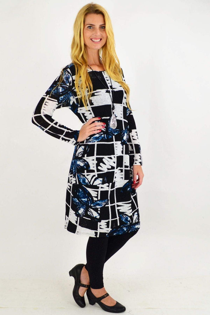Vuios Heidi Floral Cocoon Tunic Dress worn by mature woman, featuring a flowing silhouette and vibrant floral pattern.