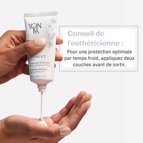 Hand dispensing cream from a tube of Hydra No. 1 Crème Hyluaronic Acid Moisturizer | Yon-Ka Paris onto palm with skincare advice text in French about optimal protection in cold weather.
