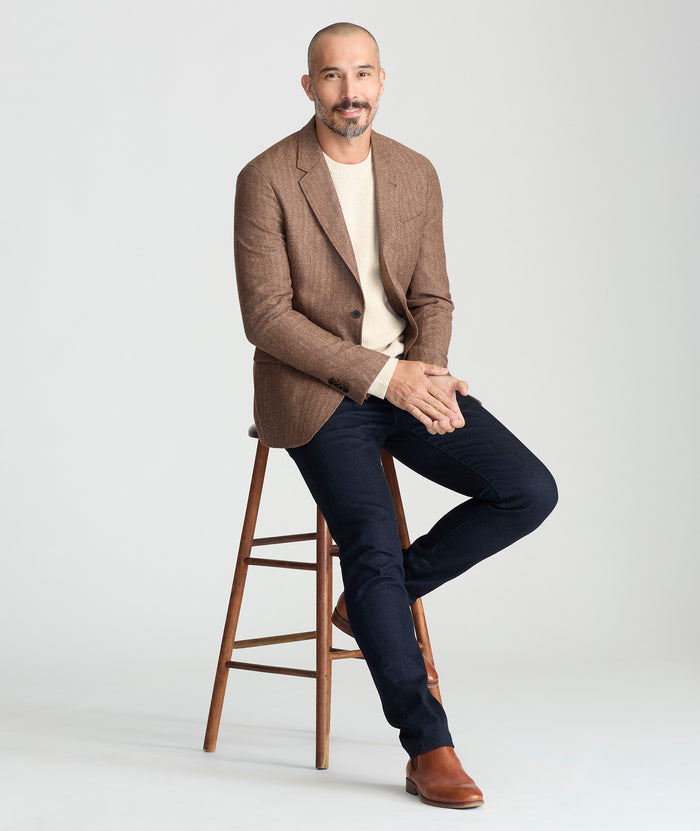 Model is wearing UNTUCKit Italian Wool Rawlins Sport Coat in Tan Herringbone.