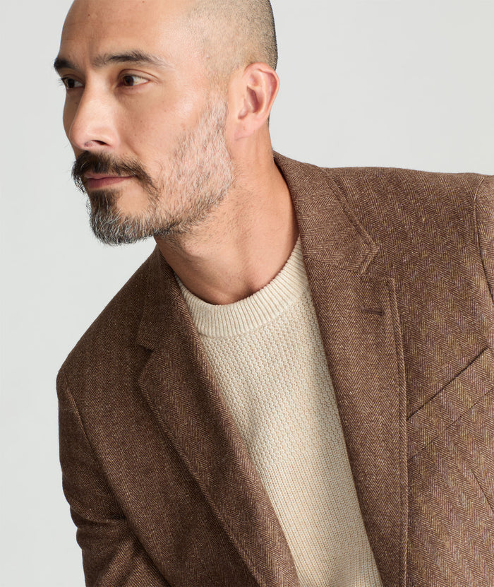 Model is wearing UNTUCKit Italian Wool Rawlins Sport Coat in Tan Herringbone.