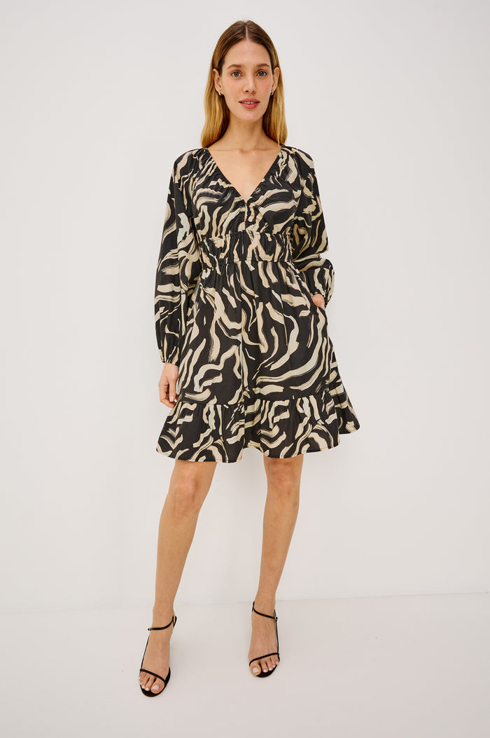 Krina Mini Dress in Cotton Poplin With Deep V-Neckline, Center Front Ties, Long Billowing Sleeves, and Tiered Hem in Caicos Colorway - Full Body Front View Featured on Model