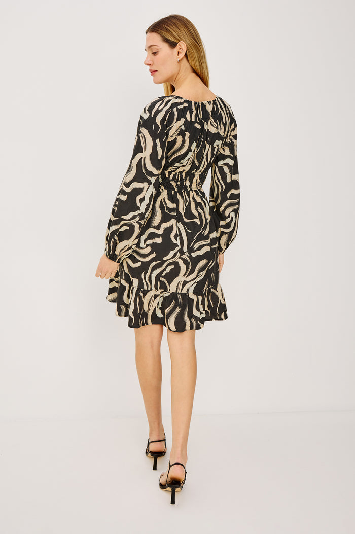 Krina Mini Dress in Cotton Poplin With Deep V-Neckline, Center Front Ties, Long Billowing Sleeves, and Tiered Hem in Caicos Colorway - Full Body Back View Featured on Model