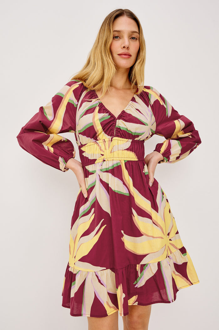 Krina Mini Dress in Cotton Poplin With Deep V-Neckline, Center Front Ties, Long Billowing Sleeves, and Tiered Hem in Red Palma Colorway - Full Body Front View Featured on Model
