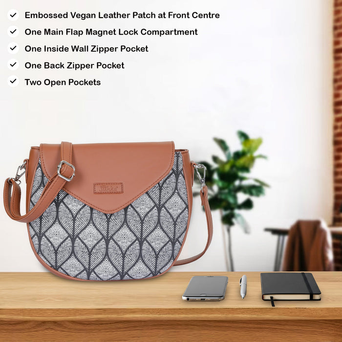 Monochrome printed canvas shoulder‑sling bag with tall soft silhouette for daily and travel use-feature image