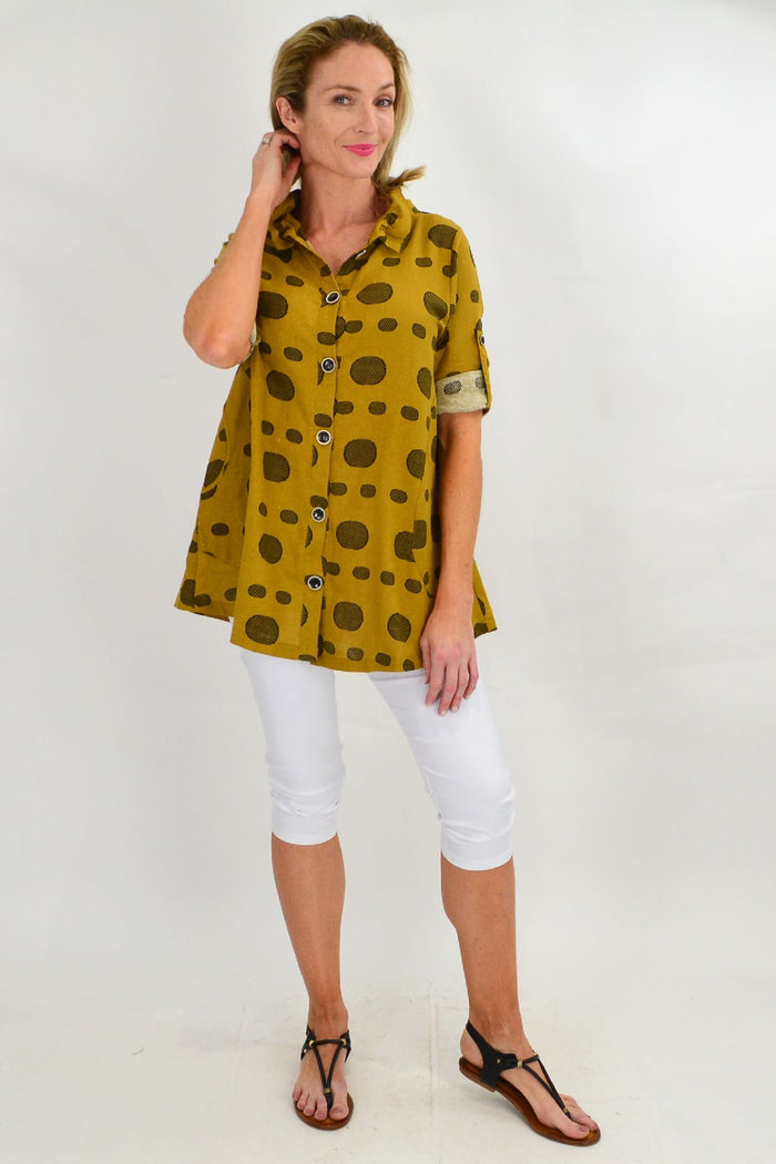 Mustard spot high collar tunic shirt by Ruby Rain, featuring a high neckline and long sleeves, displayed on a hanger.