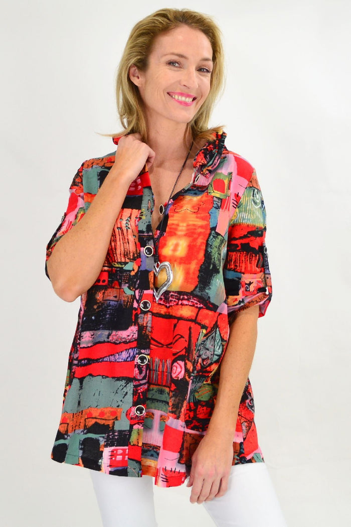 Orange Ruby Rain train high collar tunic shirt with long sleeves and a relaxed fit, displayed on a hanger.
