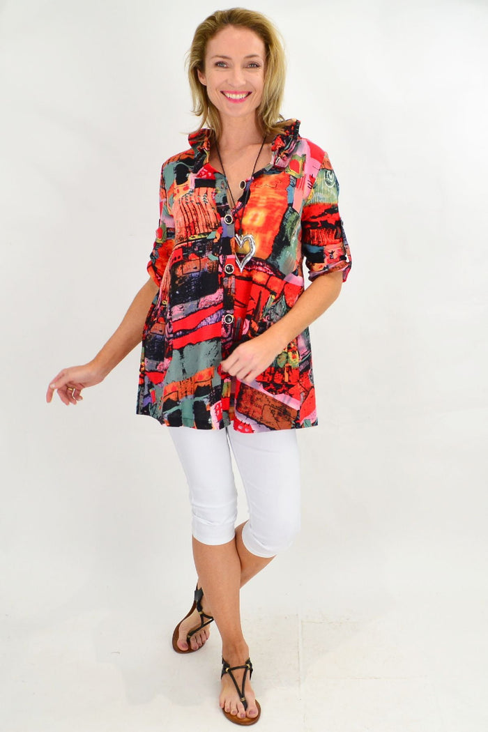 Orange train high collar tunic shirt by Ruby Rain, featuring a stylish high collar and relaxed fit, displayed on a hanger.