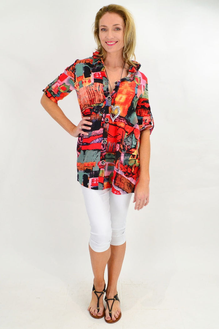Orange Ruby Rain train high collar tunic shirt with long sleeves and button details, displayed on a hanger.
