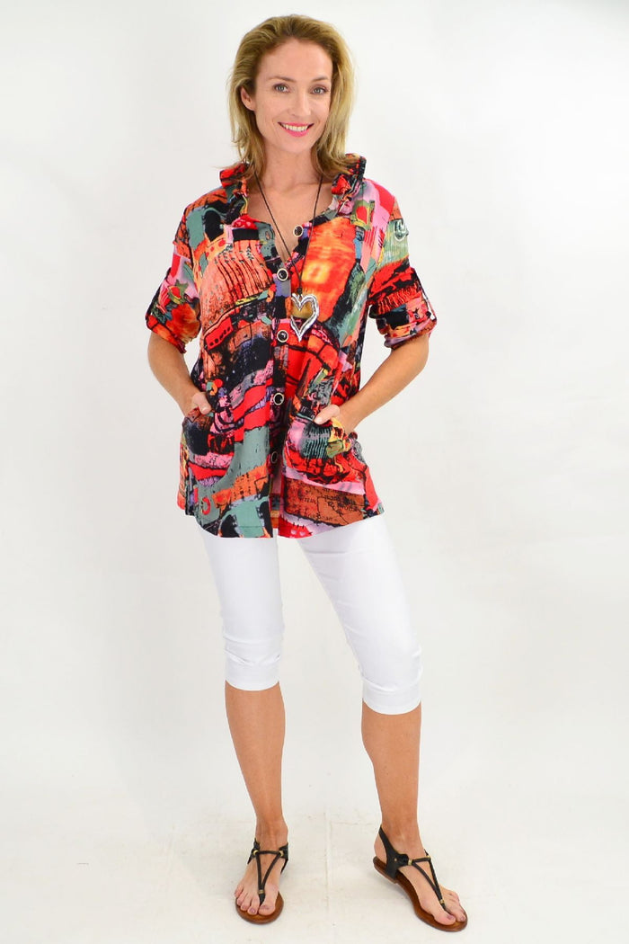 Orange Ruby Rain train high collar tunic shirt with long sleeves and button details, displayed on a hanger.