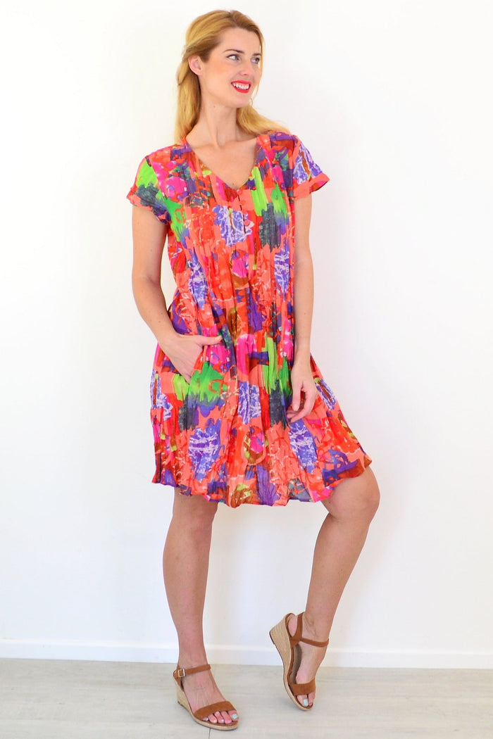 Orange tropical Nicola tunic by One Summer with cap sleeves, featuring a vibrant floral pattern and relaxed fit.