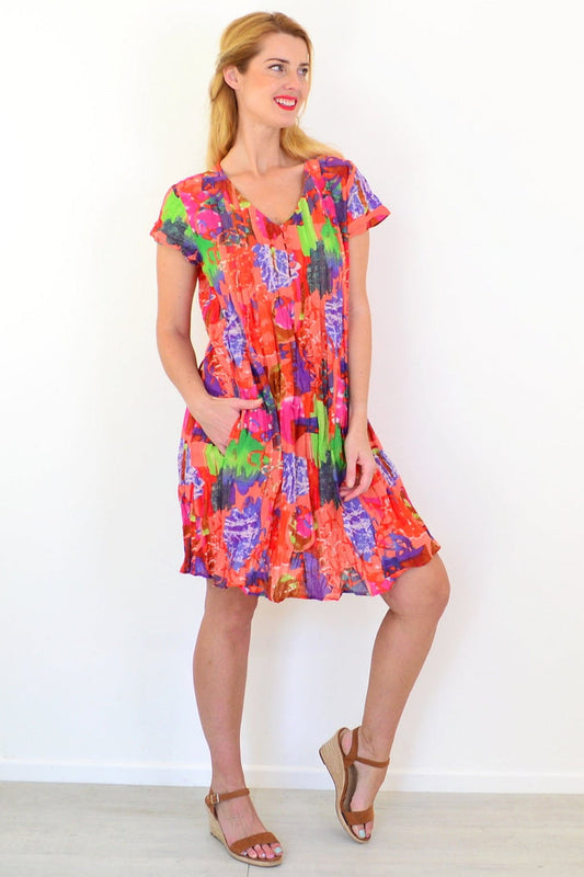 Orange tropical Nicola tunic by One Summer with cap sleeves, featuring a vibrant floral pattern and relaxed fit.