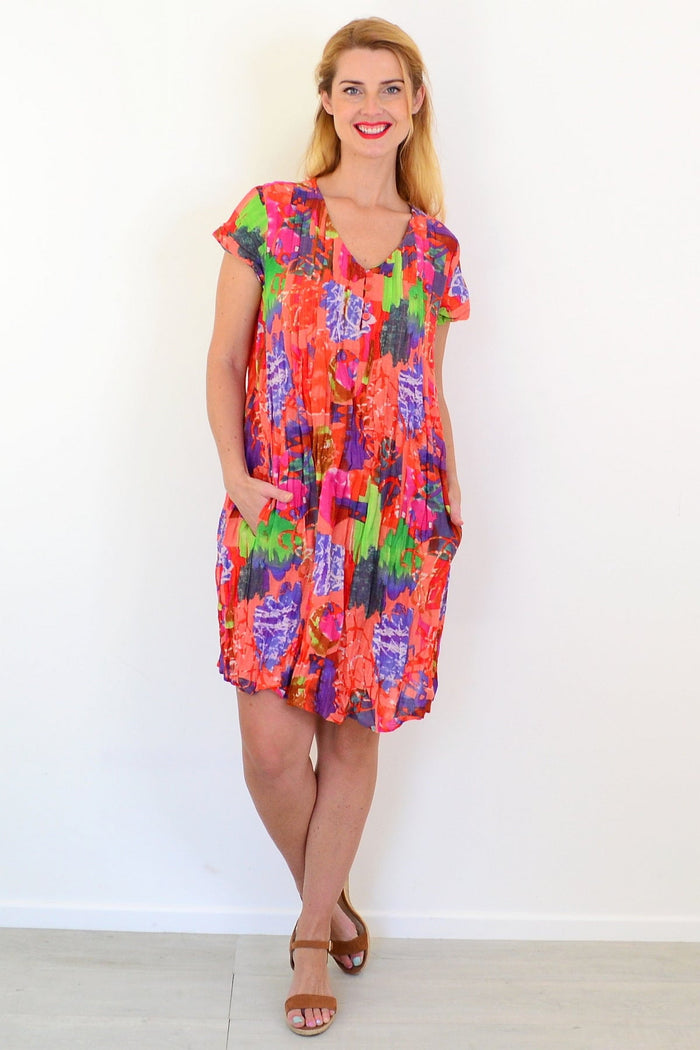Orange tropical Nicola tunic dress with cap sleeves by One Summer, featuring vibrant floral fabric and casual, flowing style.