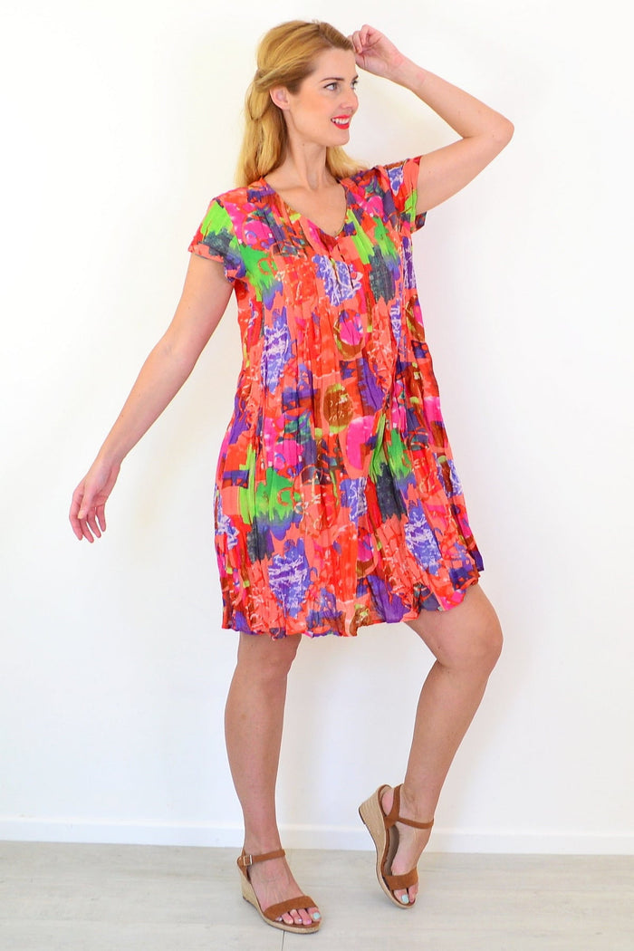 Orange tropical Nicola tunic by One Summer with cap sleeves, lightweight fabric, and vibrant tropical print.