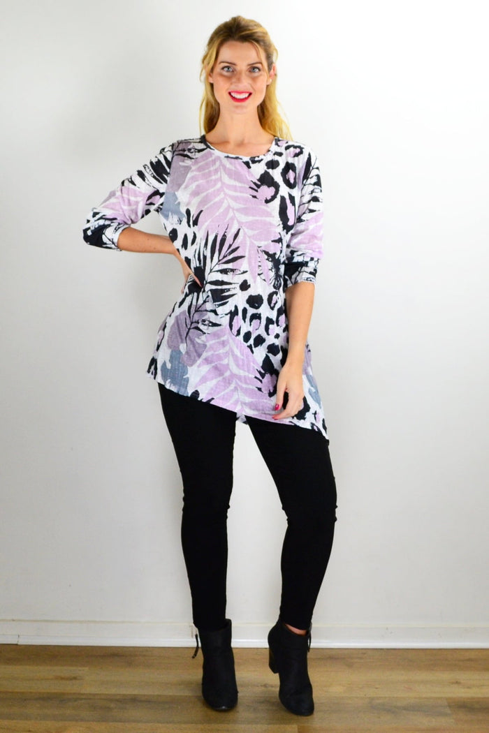 Pink jungle print crinkle tunic top by Cafe Latte displayed on a hanger with vibrant, tropical-inspired fabric and relaxed fit.