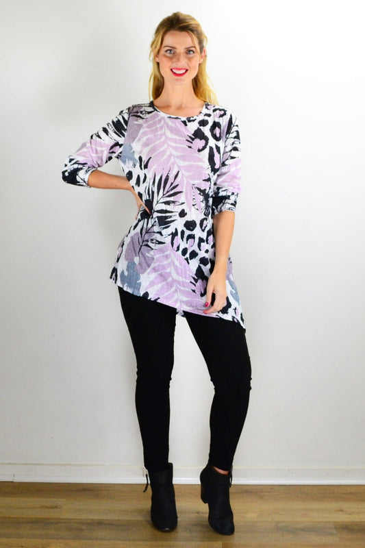 Pink jungle print crinkle tunic top by Cafe Latte displayed on a hanger with vibrant, tropical-inspired fabric and relaxed fit.