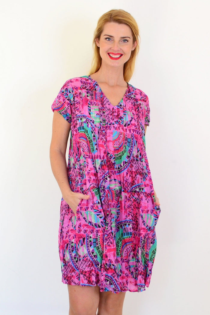 Pink tropical Nicola dress tunic by One Summer with cap sleeves, featuring a vibrant, tropical pattern on lightweight fabric.