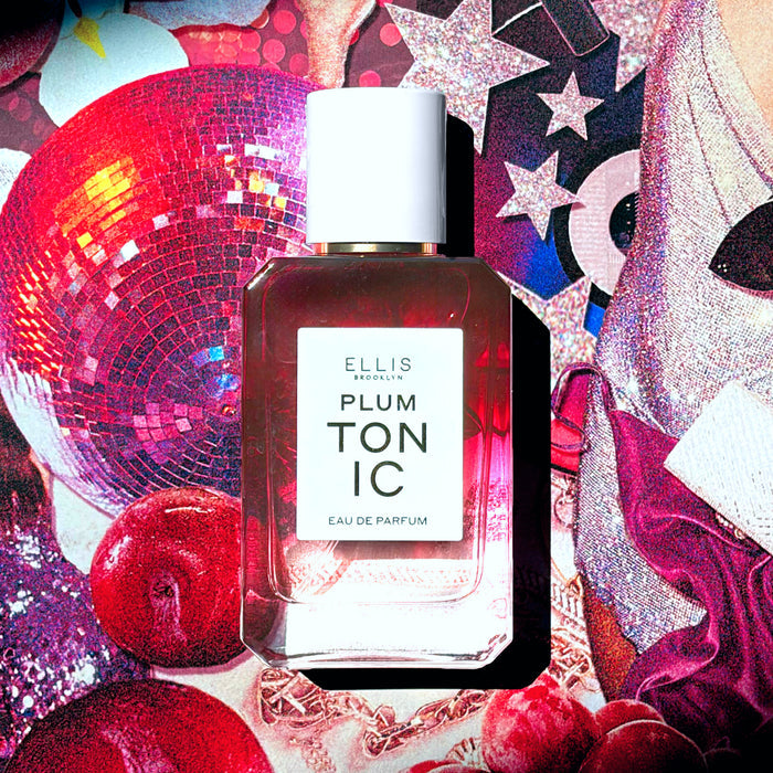 PLUM TONIC Eau de Parfum 50ml on collage of pink sequins, pink glittery stars, a pink disco ball, plums, a woman wearing a silver sequin dress and clutch, pink fabric, and a rose gold chain necklace
