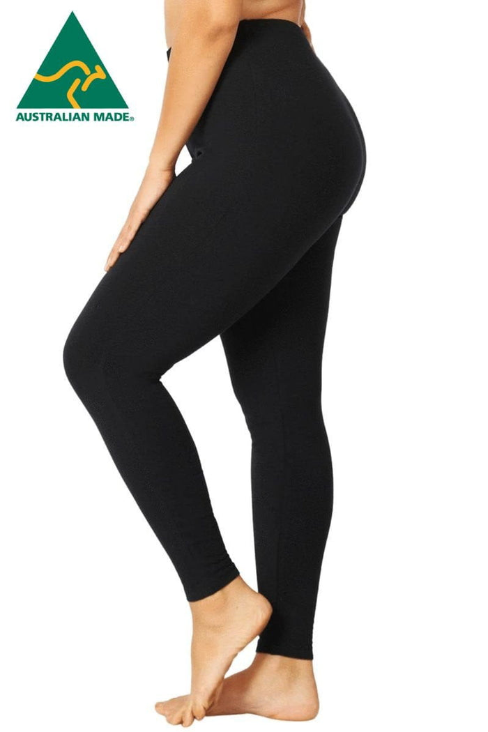 Plus size black leggings by Room to Move, shown in a full-length view, highlighting their comfortable fit and stretchy fabric.
