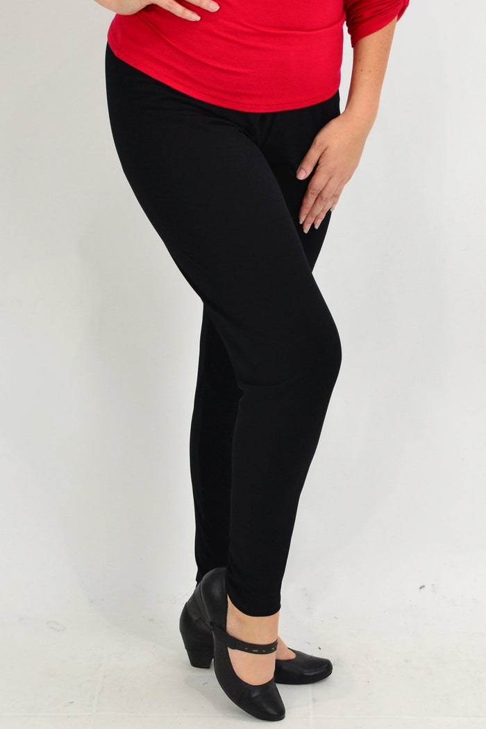 Plus size black leggings by Room to Move, featuring a comfortable fit and stretch fabric, shown on a model.