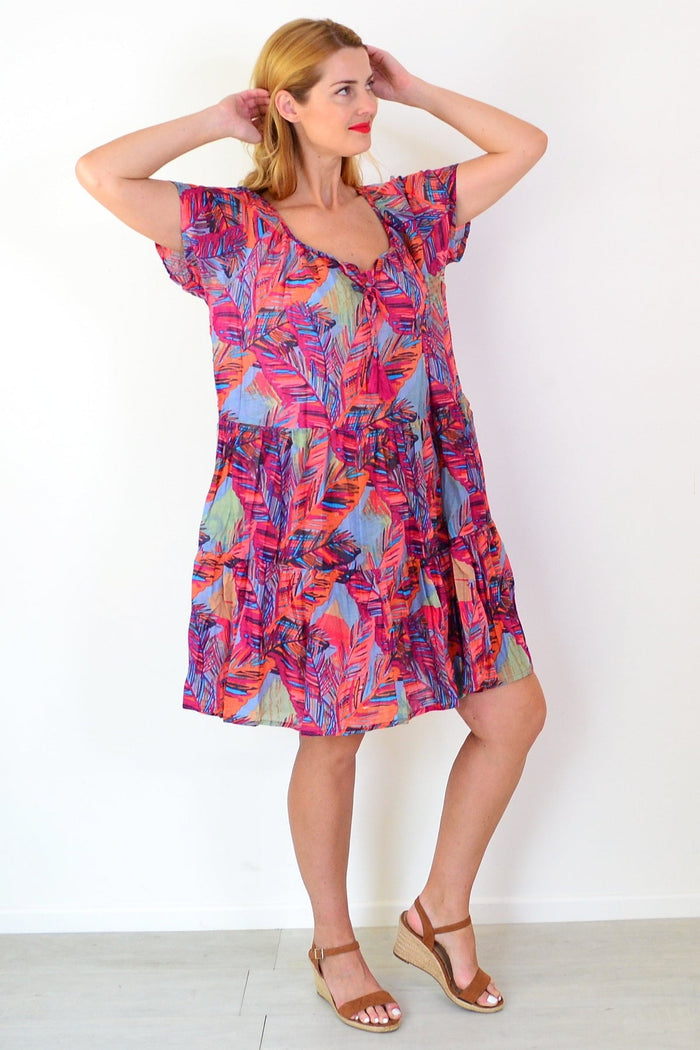 Poppy Palm Leaves cap sleeve dress by One Summer, a stylish tunic with tropical leaf pattern and relaxed fit, displayed on a hanger.