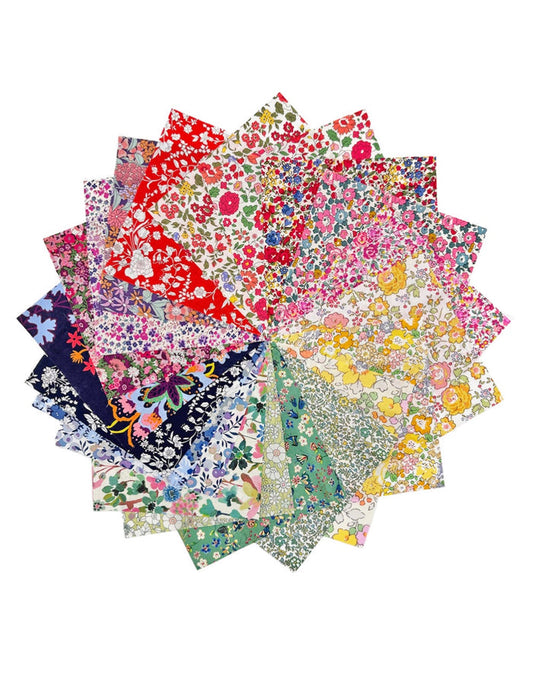 Stack of colorful floral fabric swatches on a white background