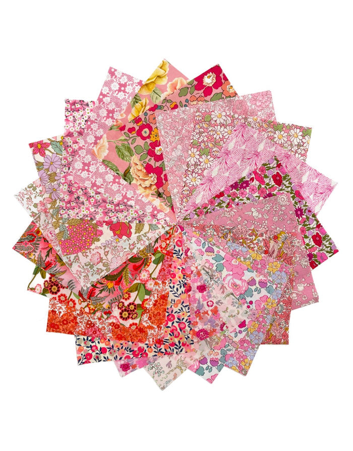 Collection of floral fabric squares in various pink tones on a white background