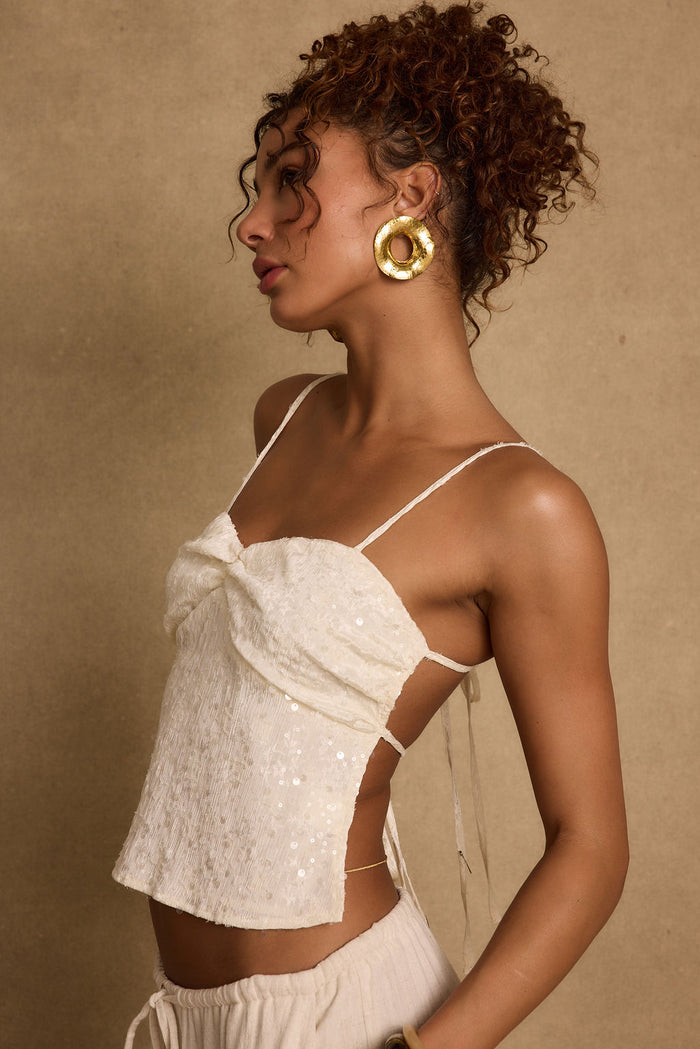 Silvia Ivory Sequin Top paired with complementary accessories for a polished look.